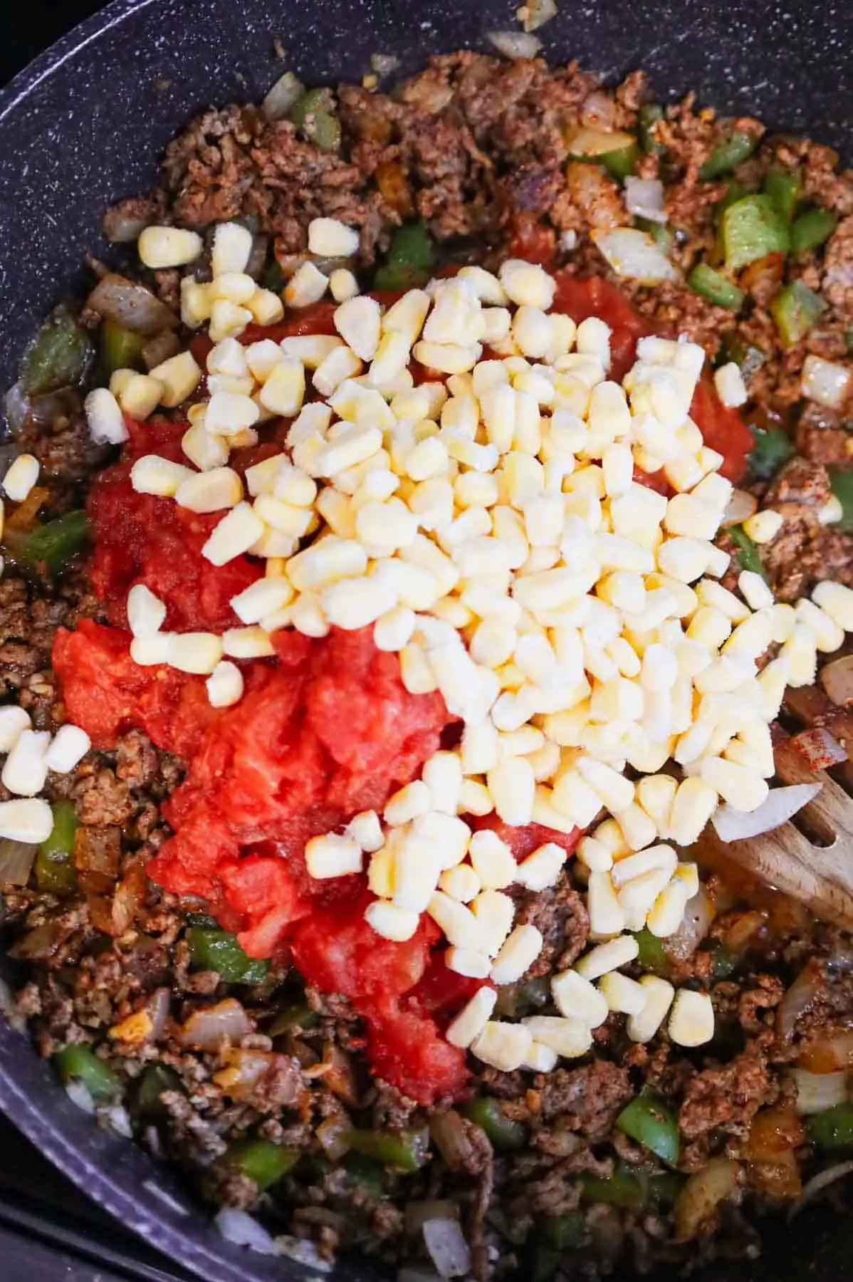 frozen corn added to skillet with Rotel, salsa and cooked ground beef