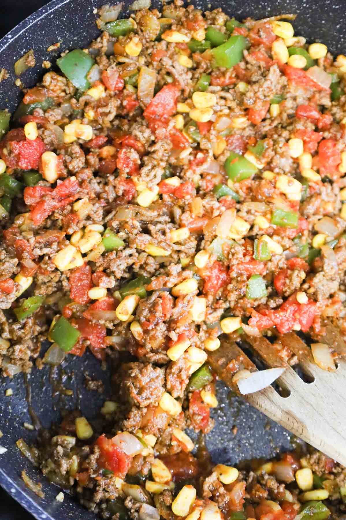 ground beef, Rotel, corn, peppers and onion mixture in a skillet