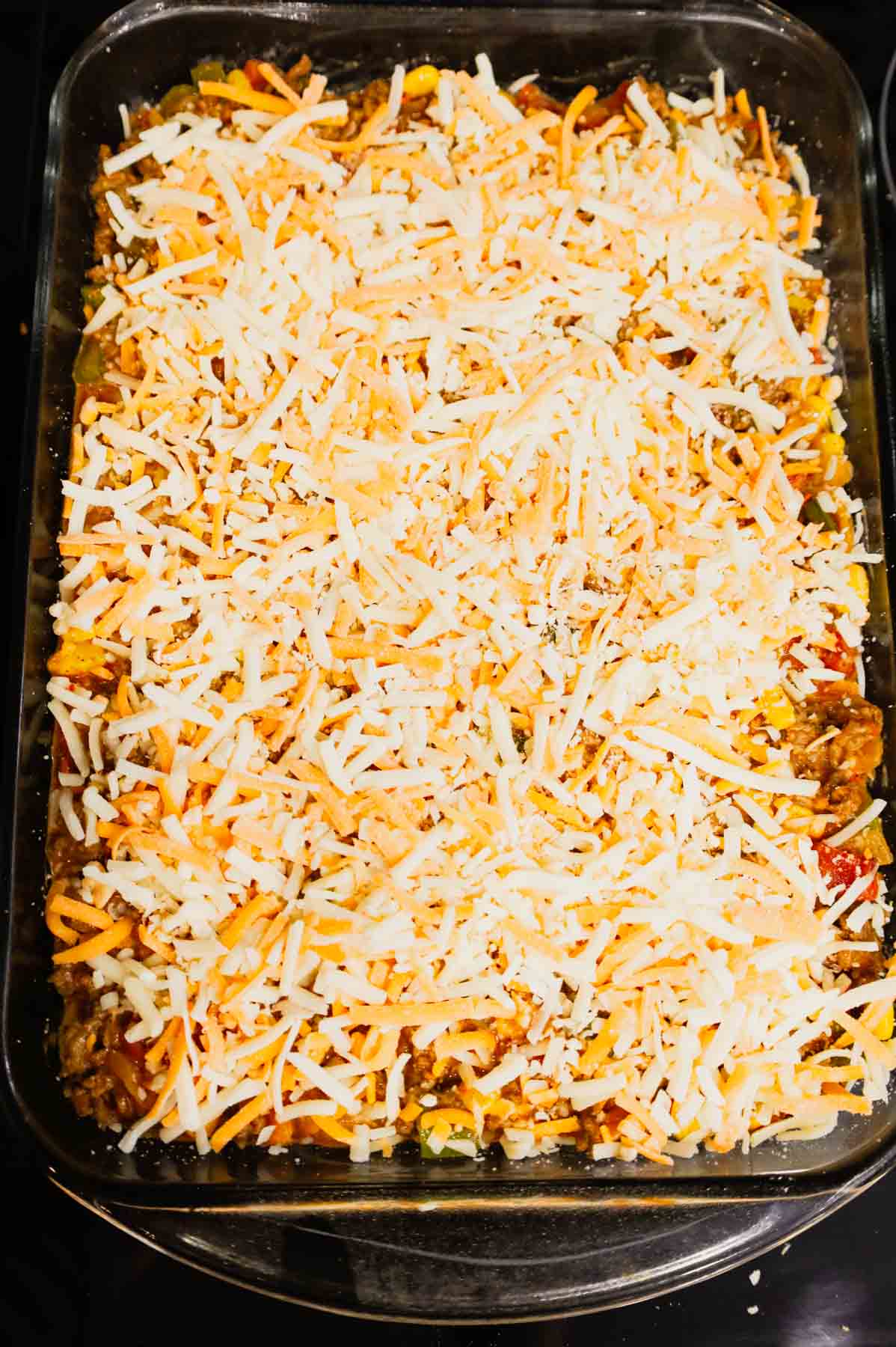 shredded cheese on top of taco potato casserole