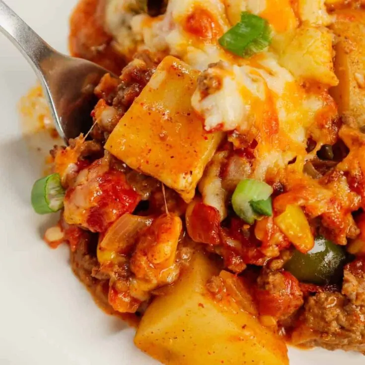 Taco Potato Casserole is a hearty dinner loaded with cubed russet potatoes, ground beef, onions, green bell peppers, Rotel diced tomatoes, salsa, taco seasoning, cheddar soup and shredded cheese.