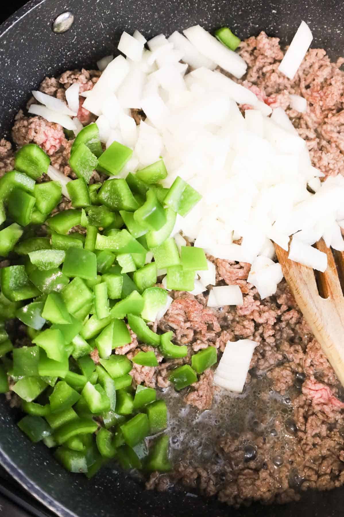 diced green peppers and onions added to skillet with ground beef