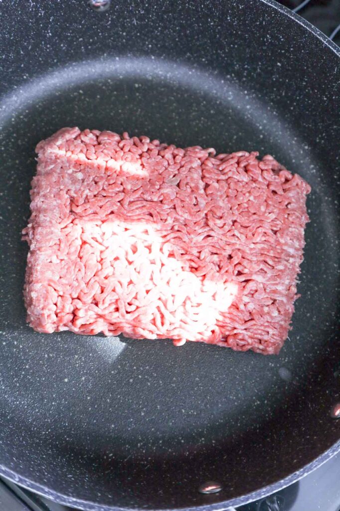 raw ground beef in a skillet