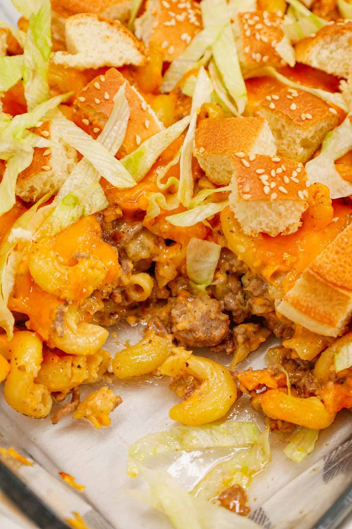 Big Mac Pasta is a hearty baked pasta recipe loaded with ground beef, diced onions, pickles, sesame seeds, Thousand Island dressing and cheddar cheese and topped with chopped hamburger buns and shredded lettuce.