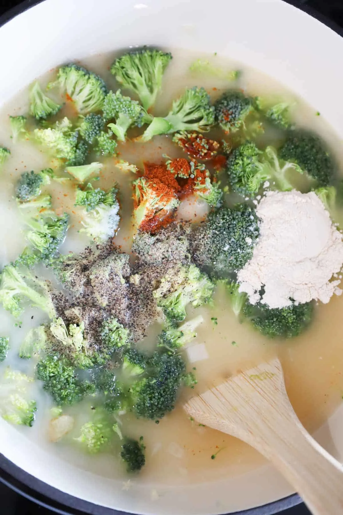 spices, broth, half and half and broccoli in a soup pot