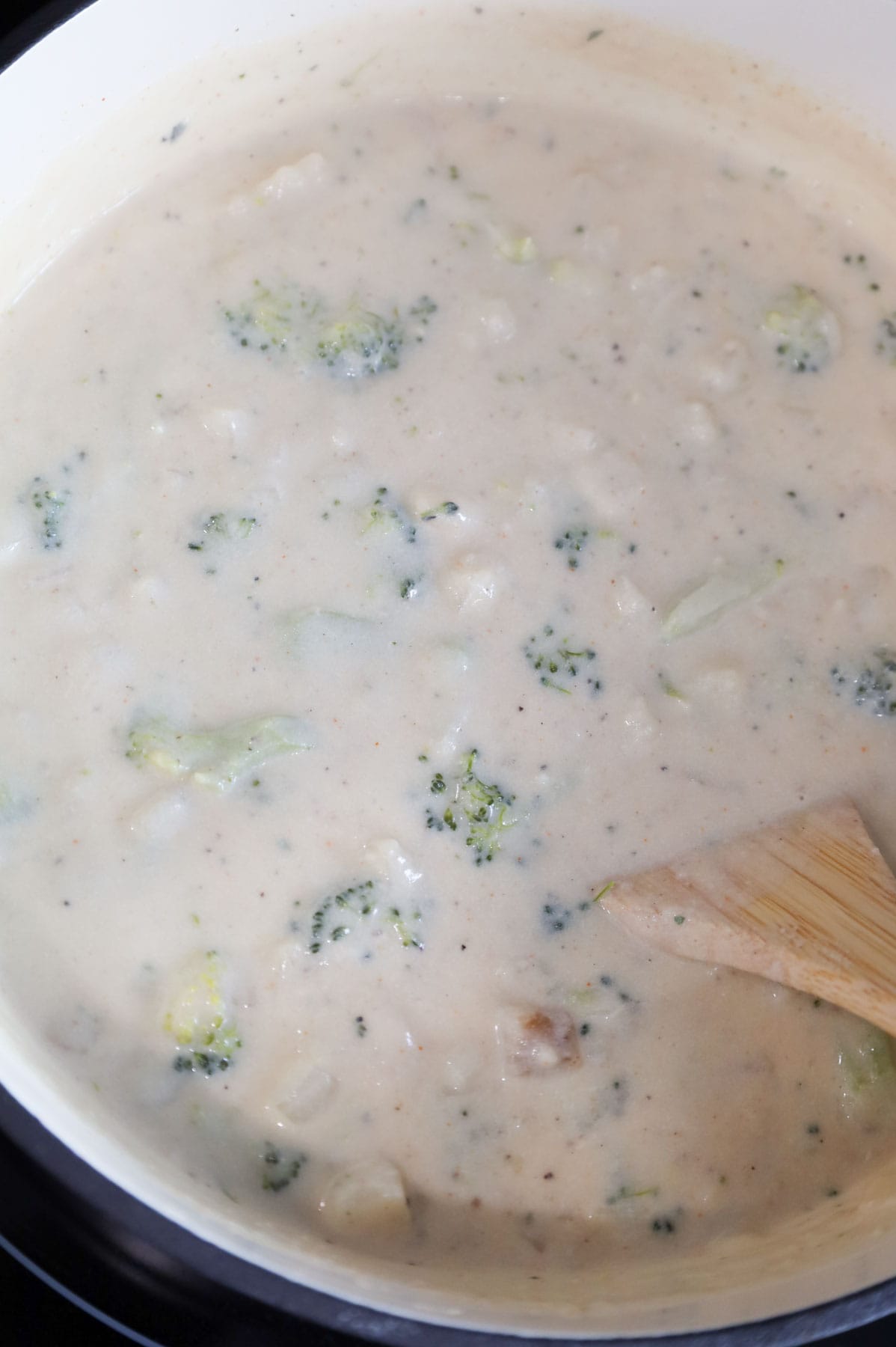 stirring instant mashed potatoes into broccoli potato soup