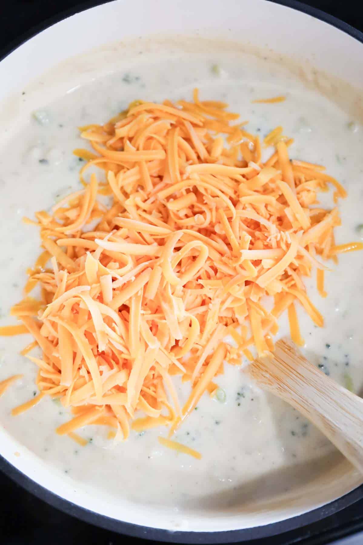 shredded cheddar cheese added to broccoli potato soup