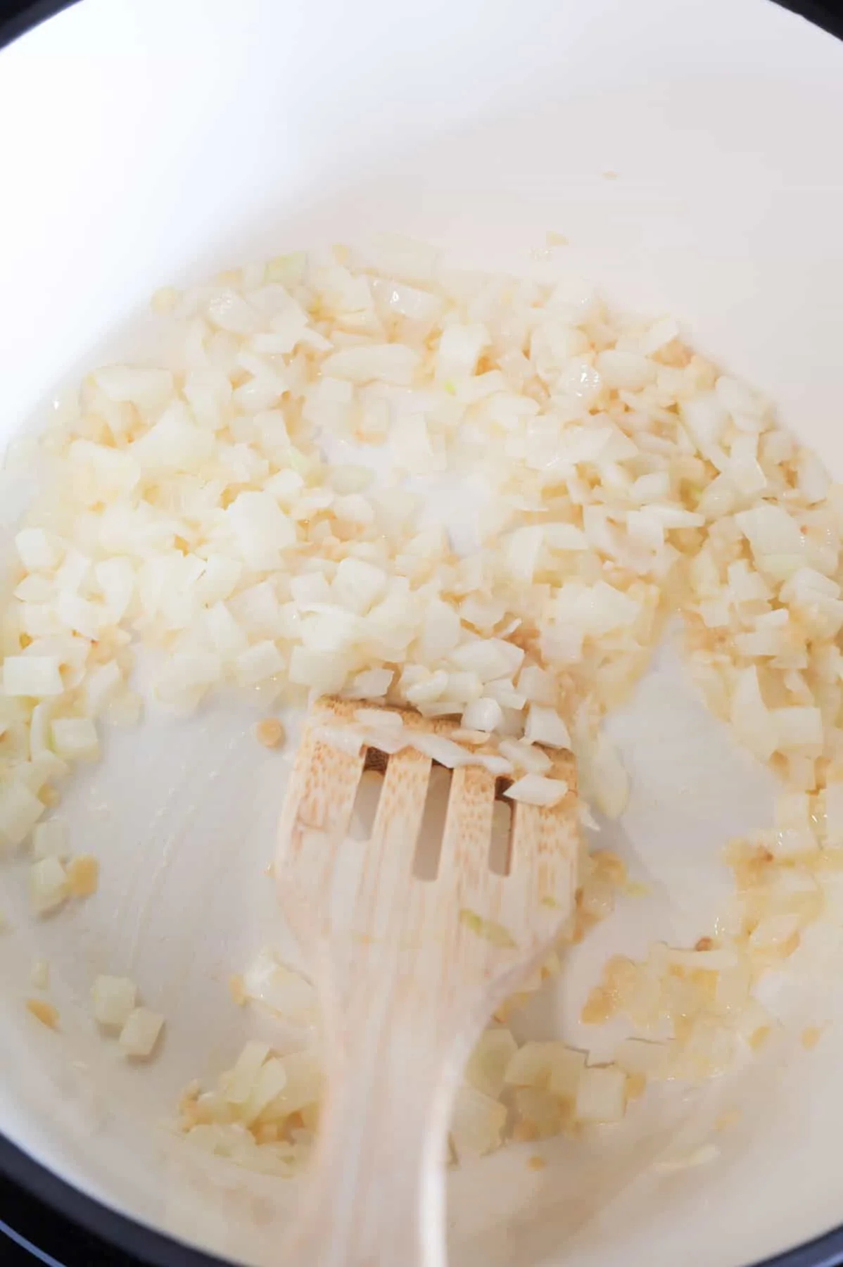 stirring diced onions and minced garlic together in a pot