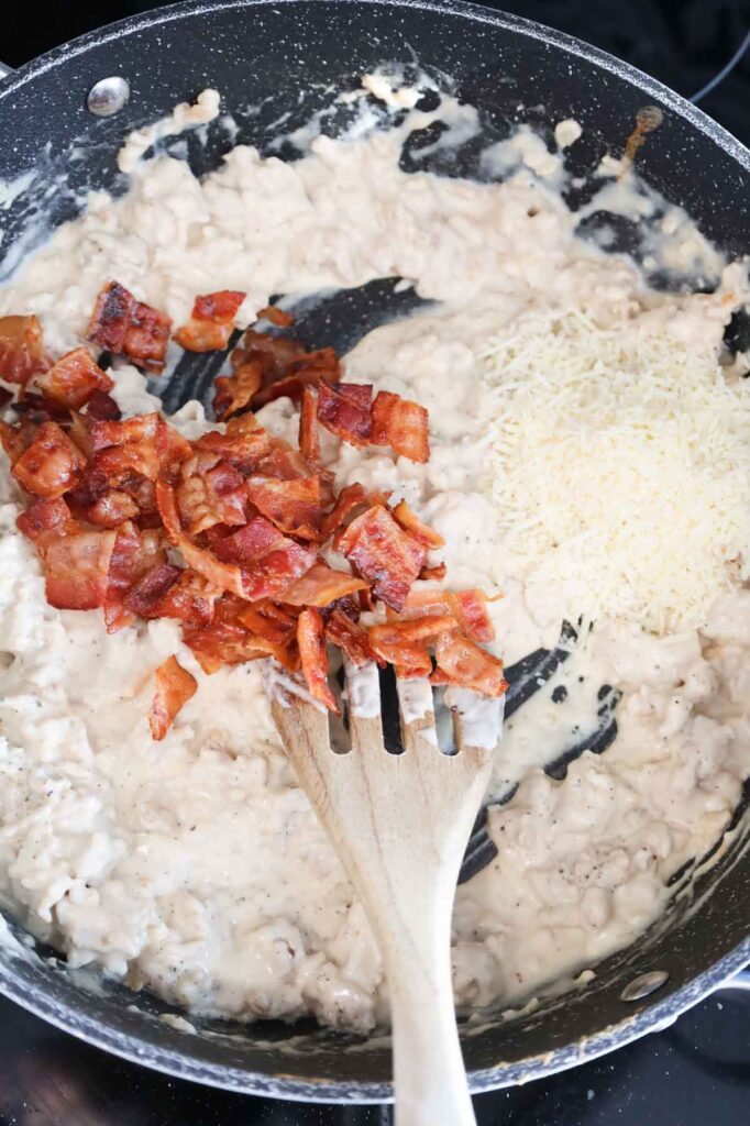 grated parmesan and cooked bacon pieces added to skillet with creamy ground chicken mixture