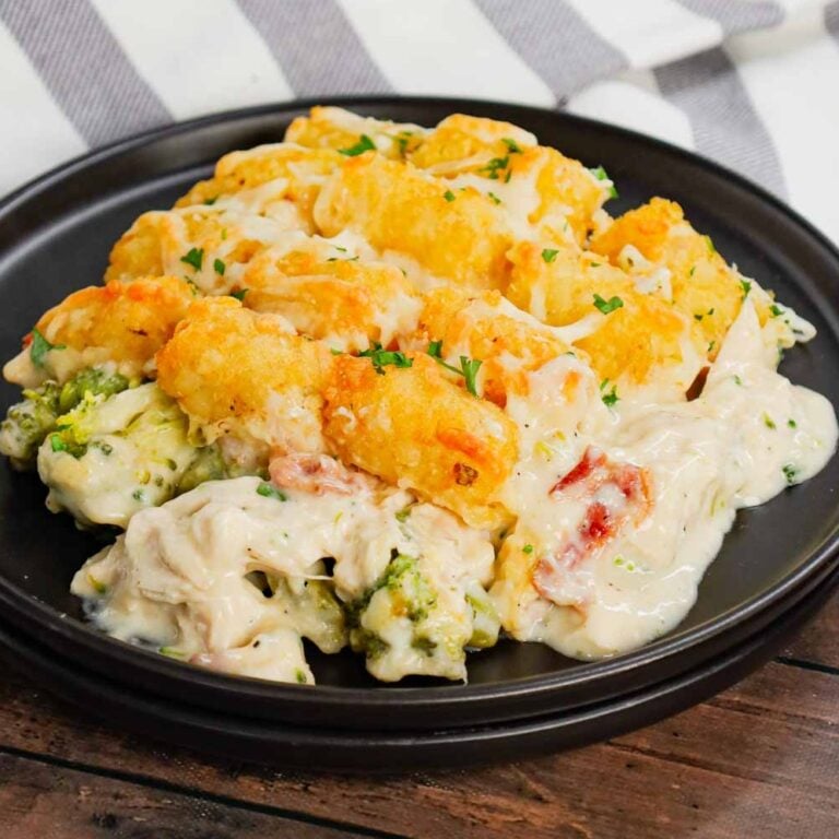 Chicken Alfredo Tater Tot Casserole is a hearty dish loaded with shredded rotisserie chicken, chopped bacon, broccoli, Alfredo sauce, parmesan and mozzarella topped with tater tots baked until golden brown and crispy.