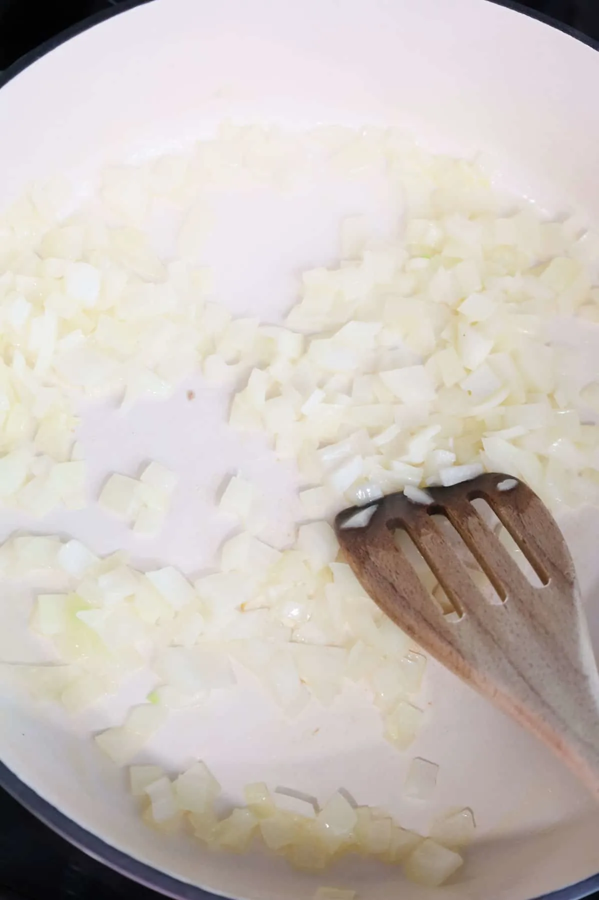 diced onions cooking in a skillet