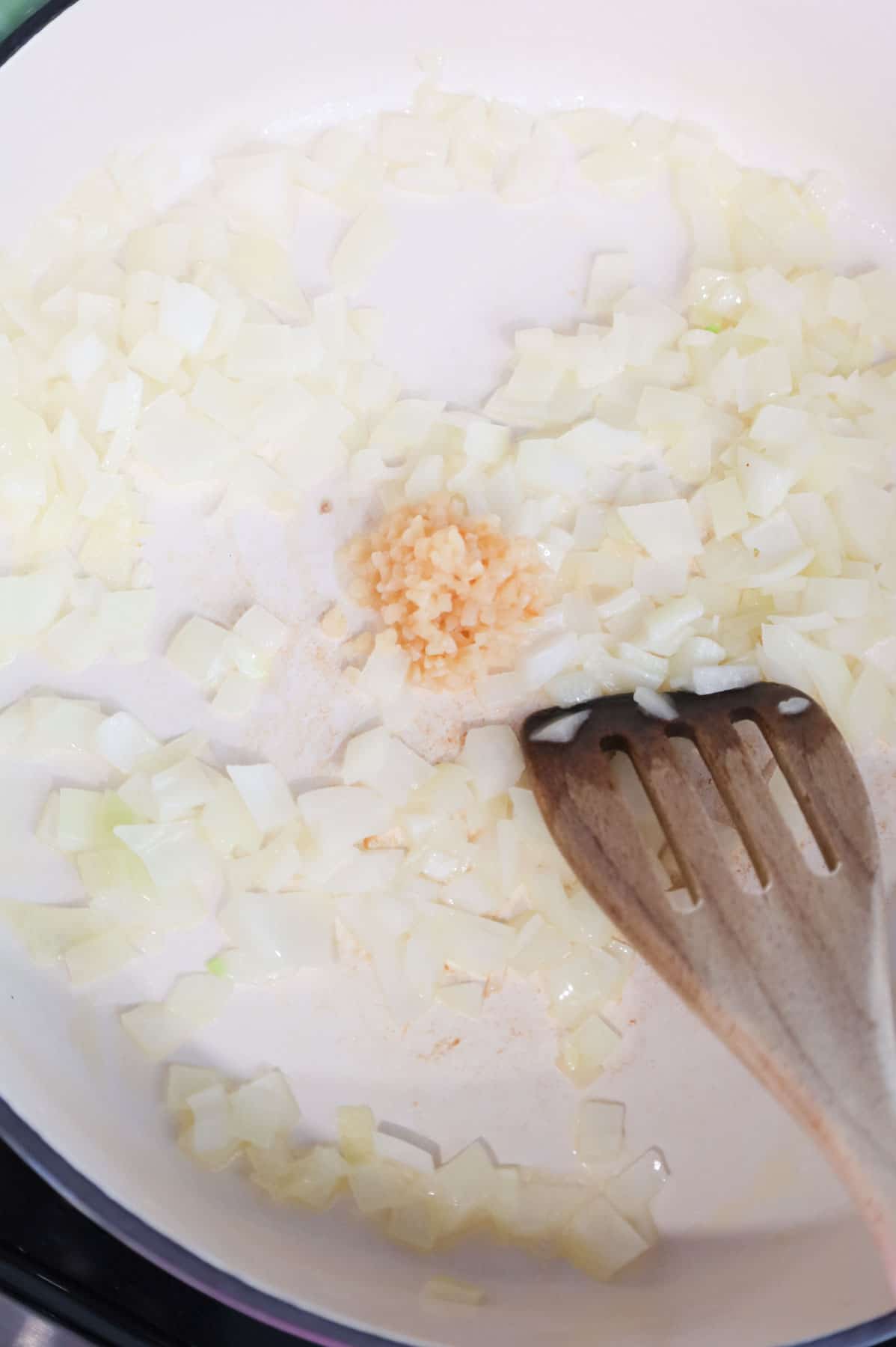 minced garlic added to a skillet with diced onions