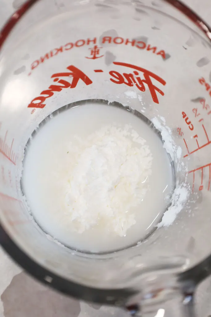 cornstarch and water in a glass measuring cup