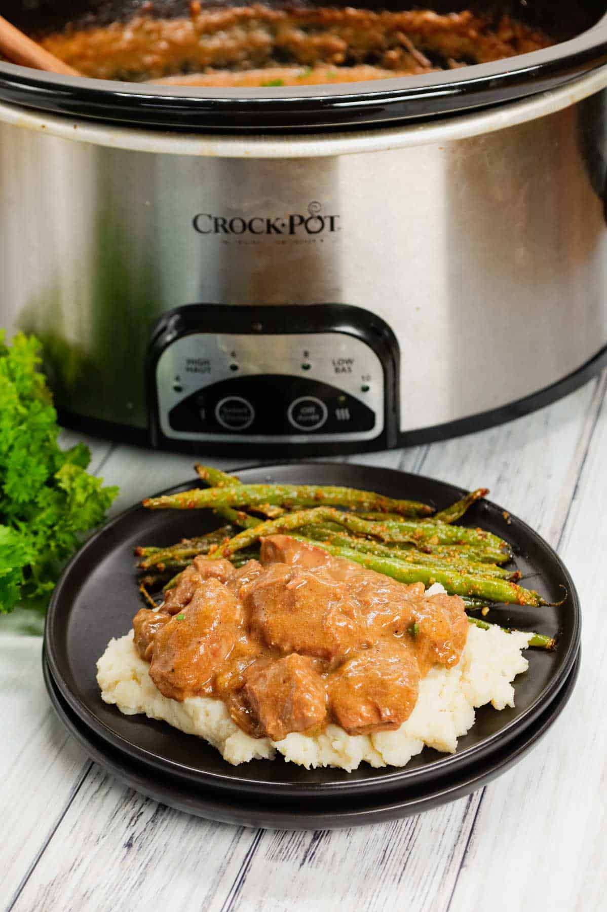 Crock Pot Beef Tips is a delicious slow cooker dinner recipe made with chunks of stewing beef, sliced onions, cream of mushroom soup, beef broth and beef gravy mix.