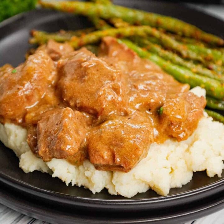 Crock Pot Beef Tips is a delicious slow cooker dinner recipe made with chunks of stewing beef, sliced onions, cream of mushroom soup, beef broth and beef gravy mix.