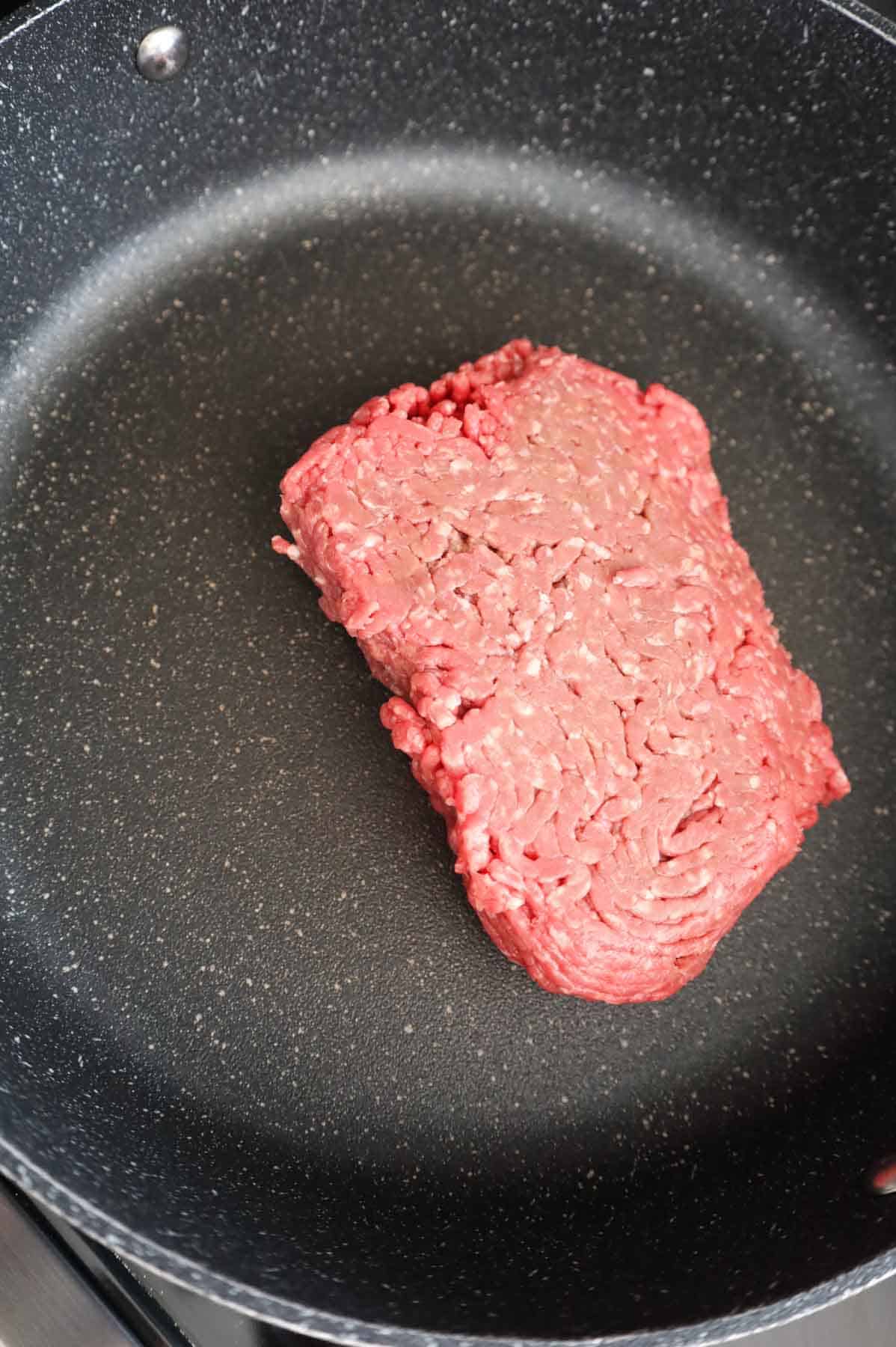 raw ground beef in a skillet