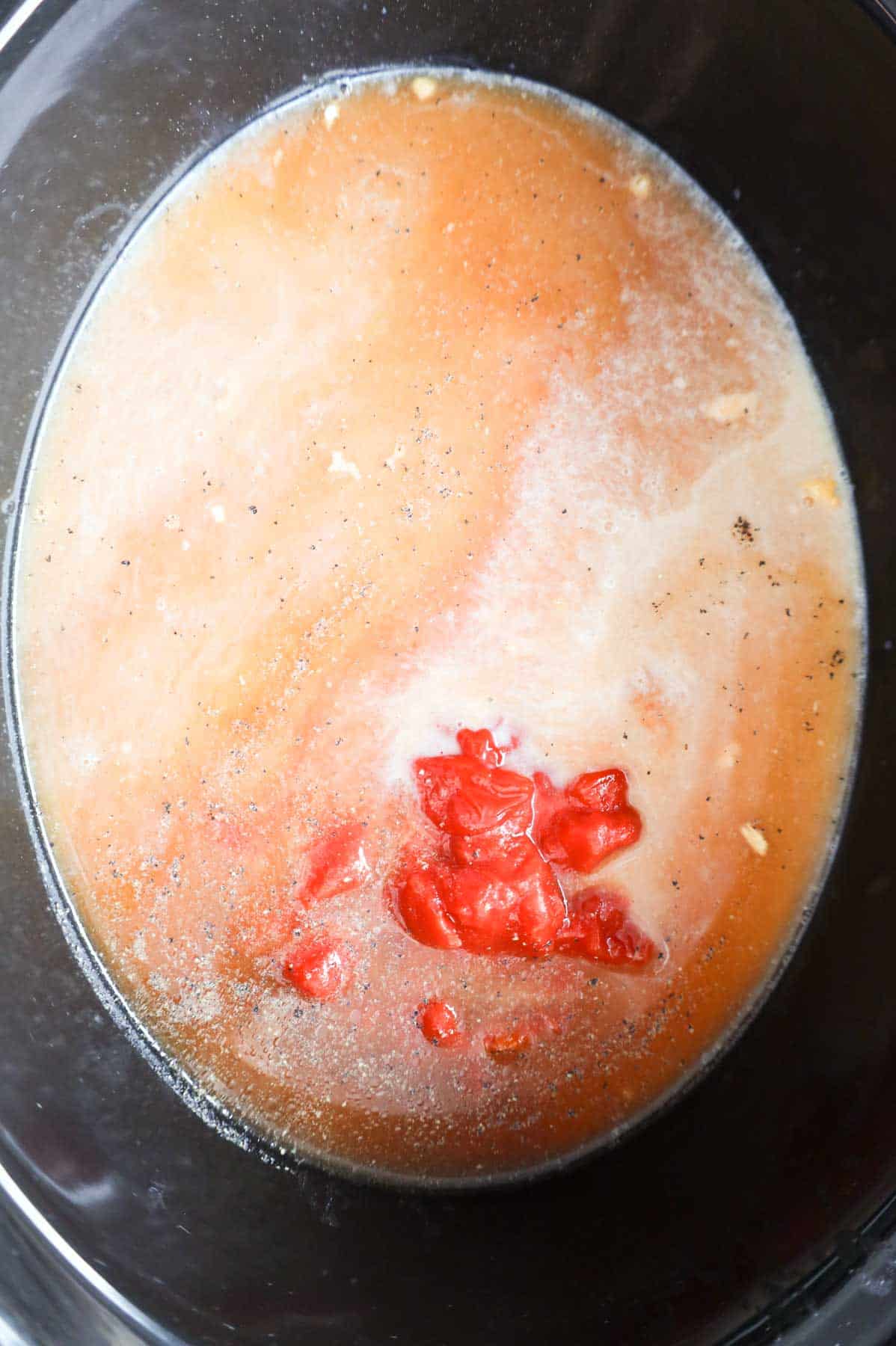 milk and beef broth added to crock pot with other hamburger helper ingredients