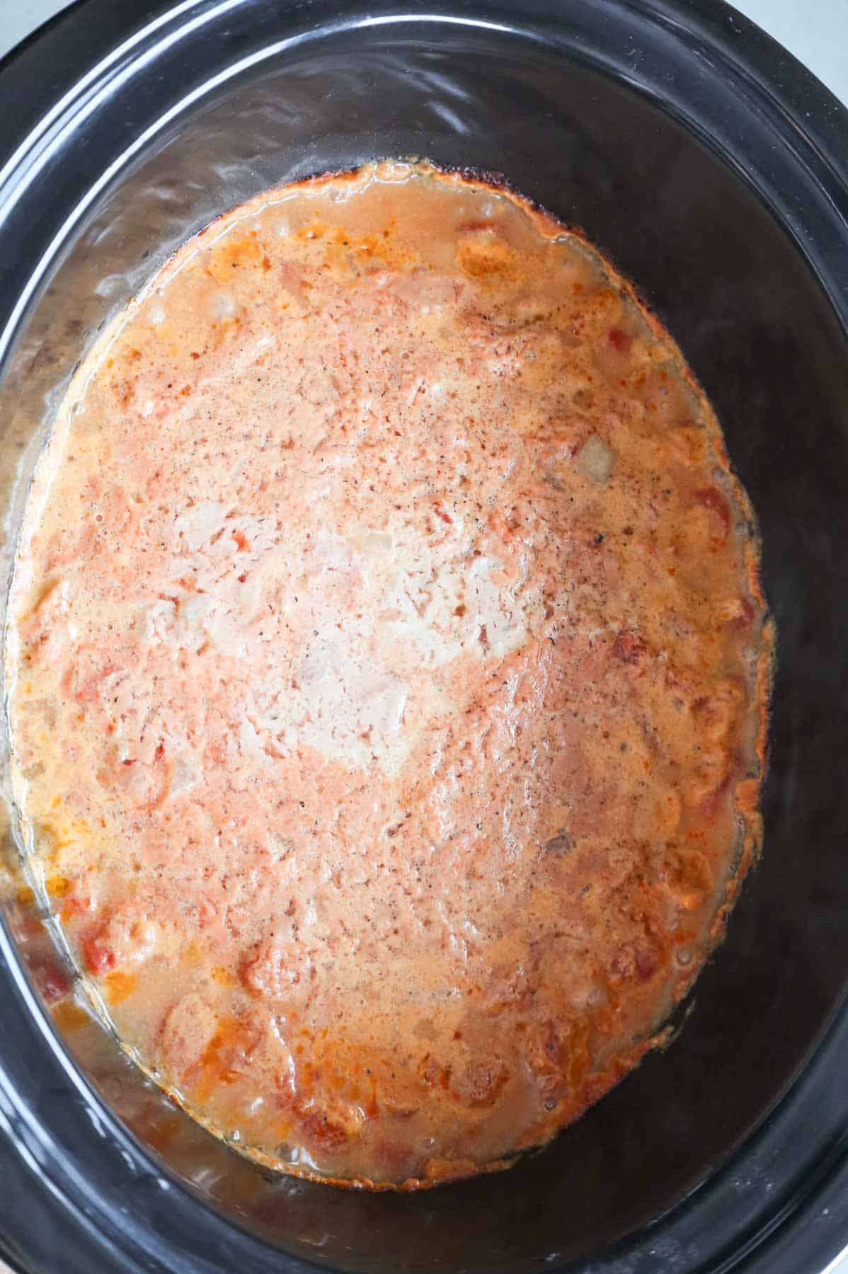 ground beef and sauce mixture cooking in a slow cooker
