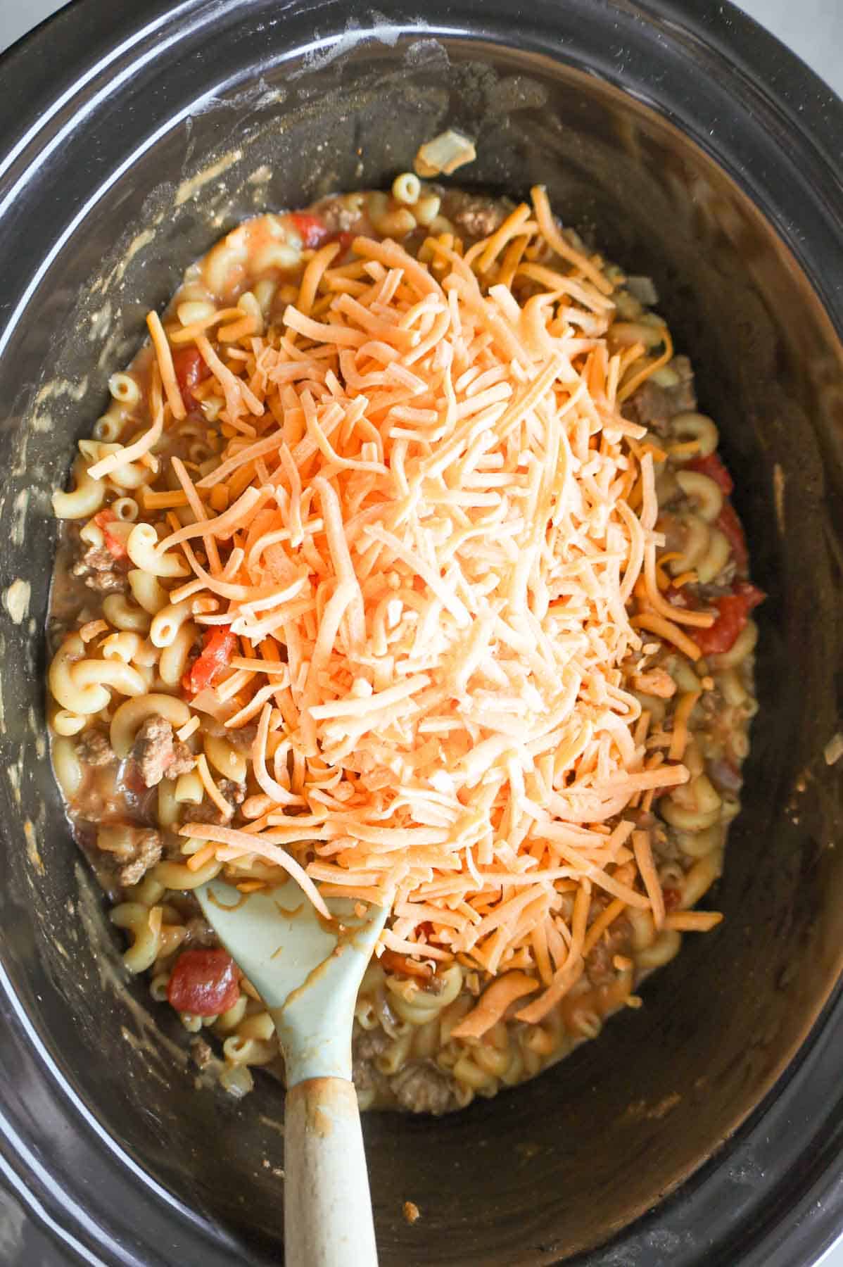 shredded cheese added to pot with hamburger macaroni