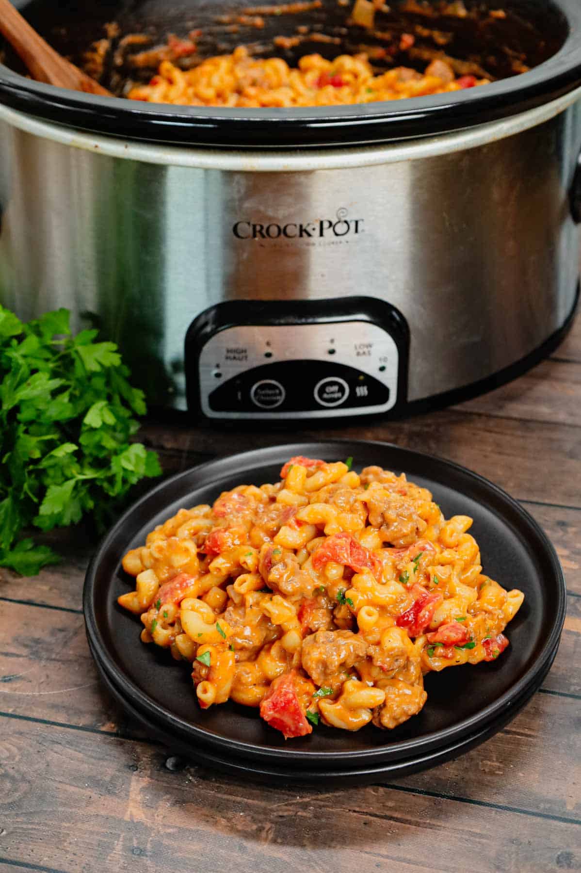 Crock Pot Hamburger Helper is a hearty slow cooker dish loaded with ground beef, diced onions, diced tomatoes, macaroni, cheddar soup and shredded cheddar cheese.