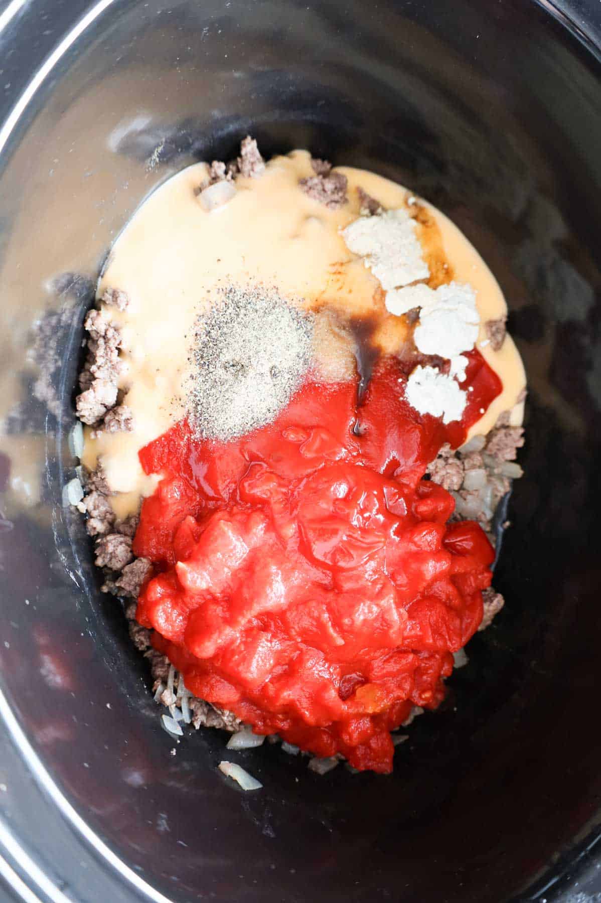 spices, diced tomatoes, cheddar soup and ground beef in a Crock Pot
