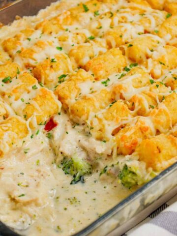 Chicken Alfredo Tater Tot Casserole is a hearty dish loaded with shredded rotisserie chicken, chopped bacon, broccoli, Alfredo sauce, parmesan and mozzarella topped with tater tots baked until golden brown and crispy.