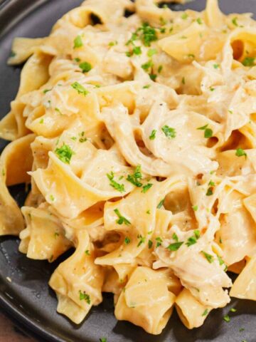 Chicken and Egg Noodles is a simple comfort food dish made with shredded rotisserie chicken, extra broad egg noodles, diced onion, cream of chicken soup and milk.