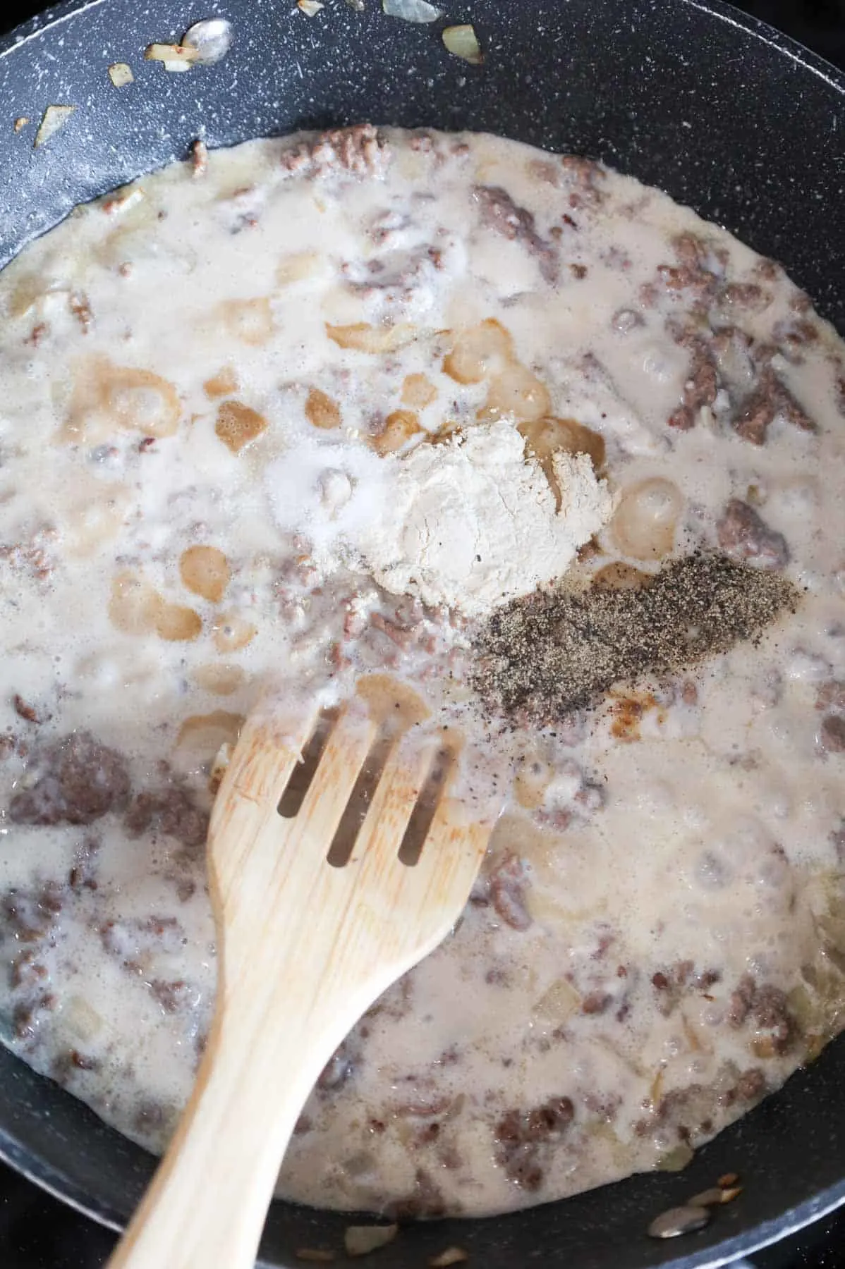 spices added to skillet with creamy ground beef mixture