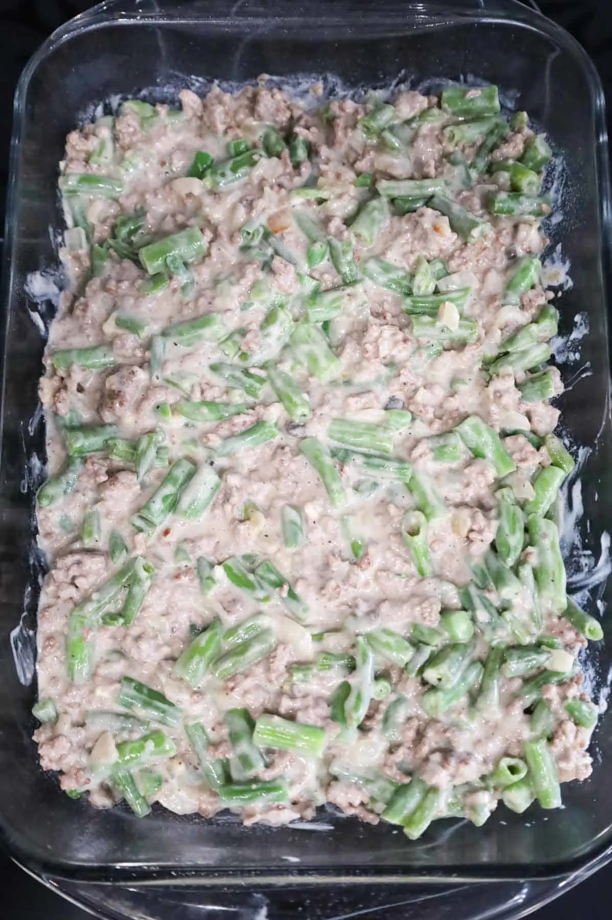 creamy ground beef and green bean mixture in a baking dish