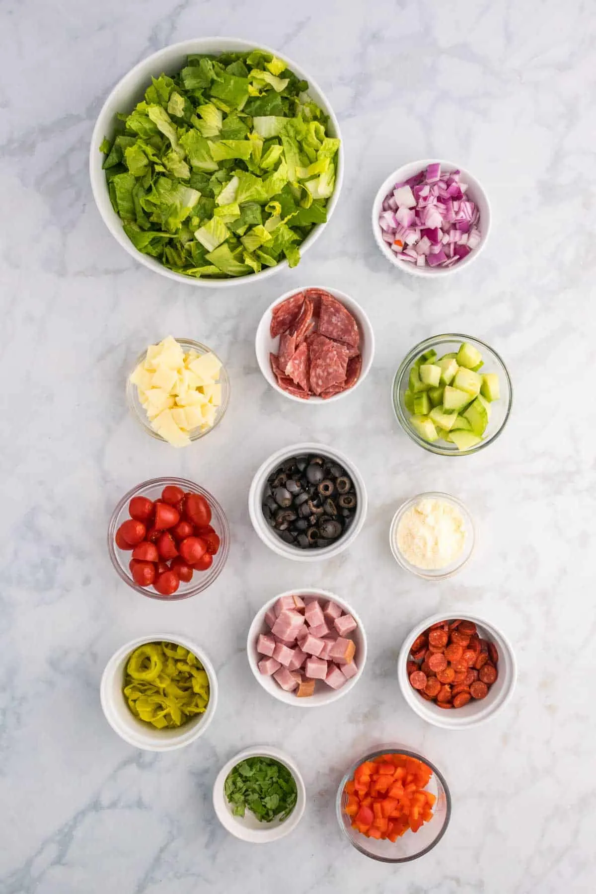 Italian sub salad ingredients in prep bowls