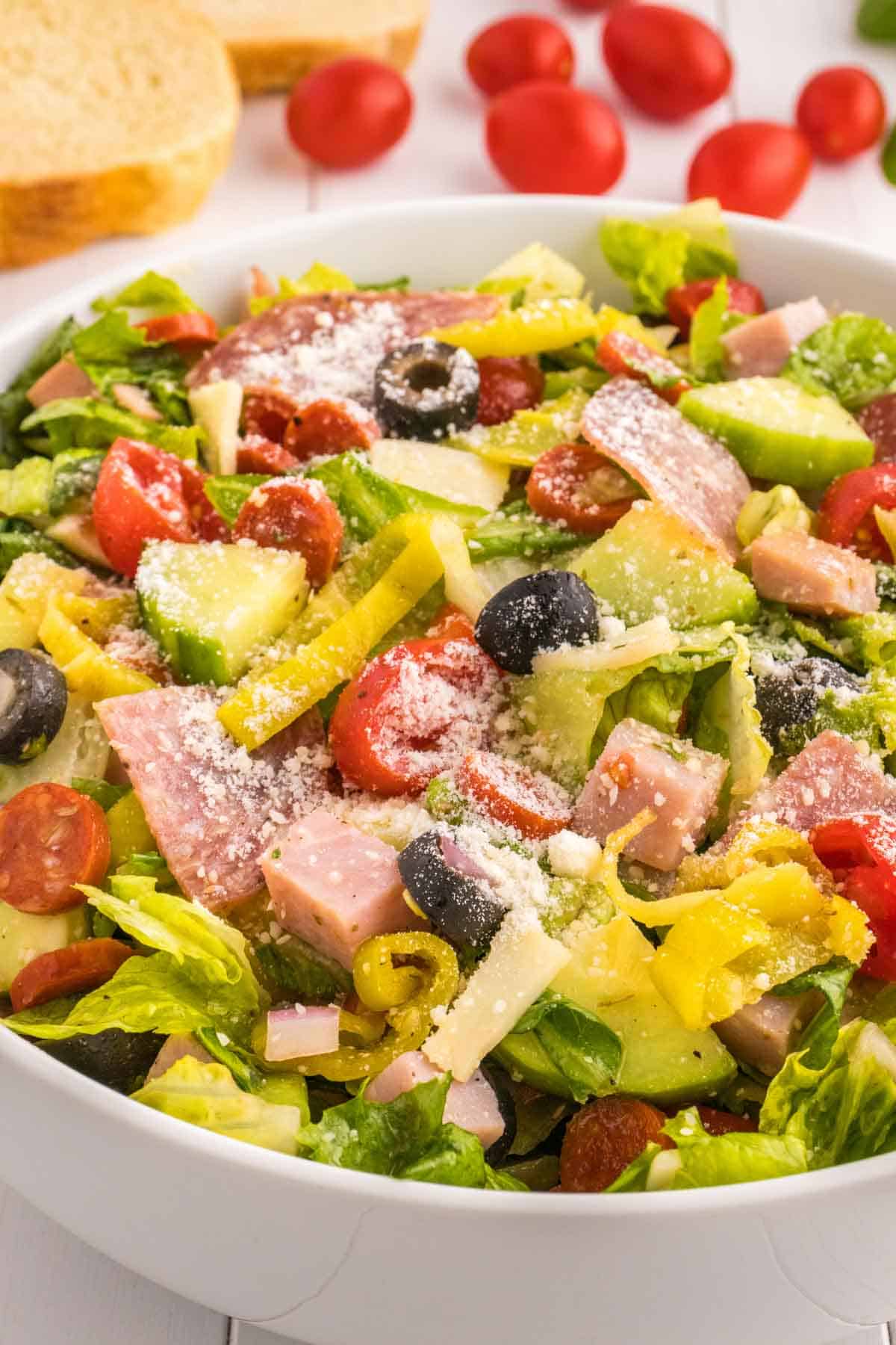 Italian Sub Salad is a delicious dish loaded with romaine, olives, tomatoes, cucumber, ham, pepperoni, peppers, onions and salami all tossed in a red wine vinegar dressing.