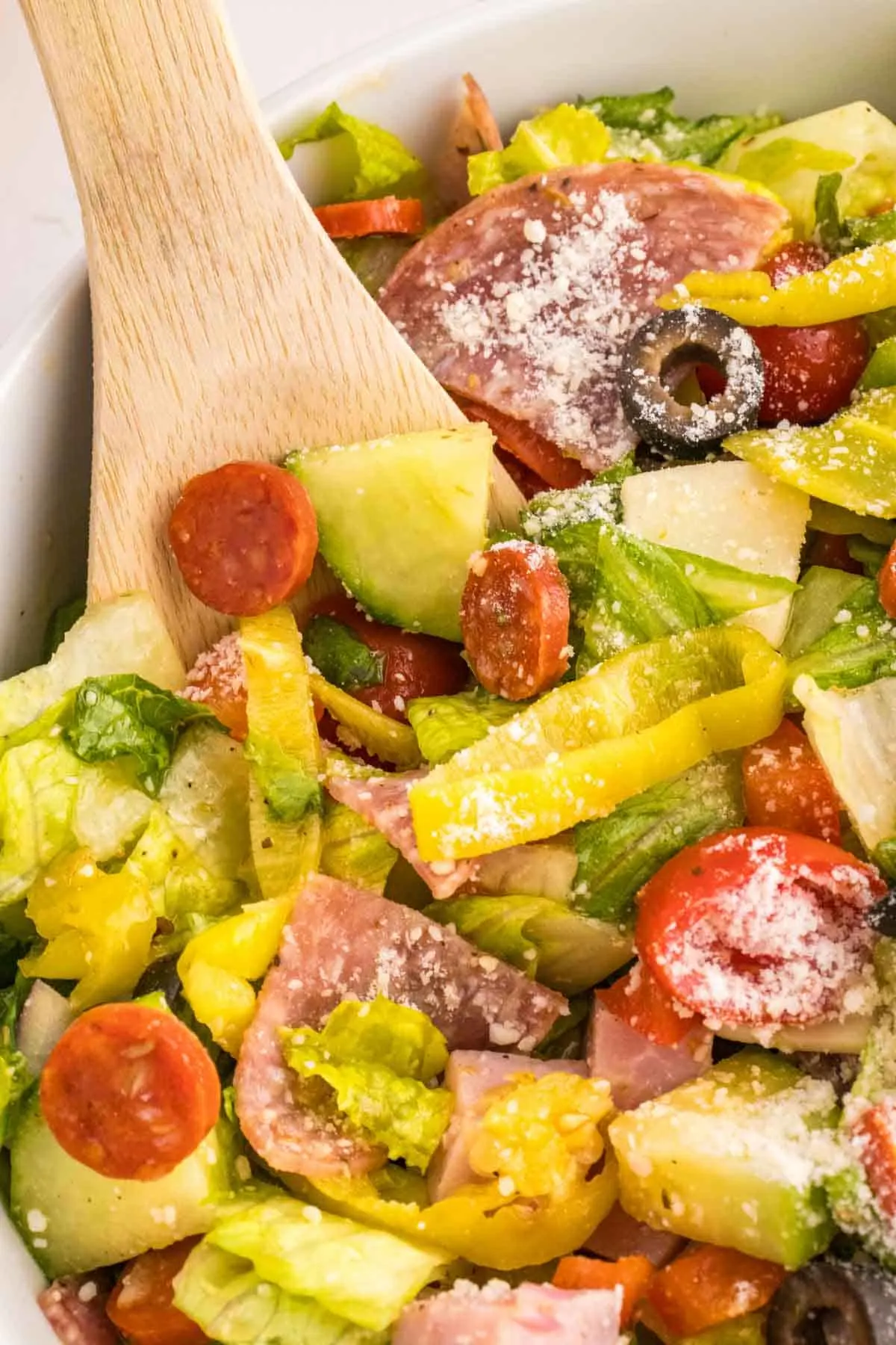 Italian Sub Salad is a delicious dish loaded with romaine, olives, tomatoes, cucumber, ham, pepperoni, peppers, onions and salami all tossed in a red wine vinegar dressing.