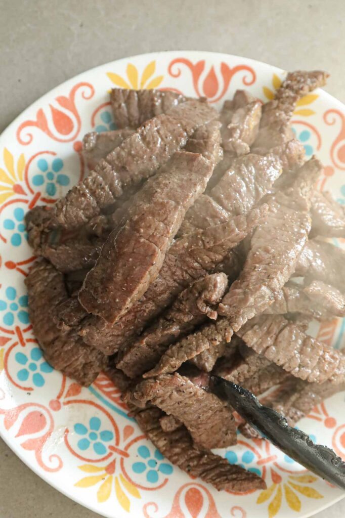 cooked steak strips on a plate