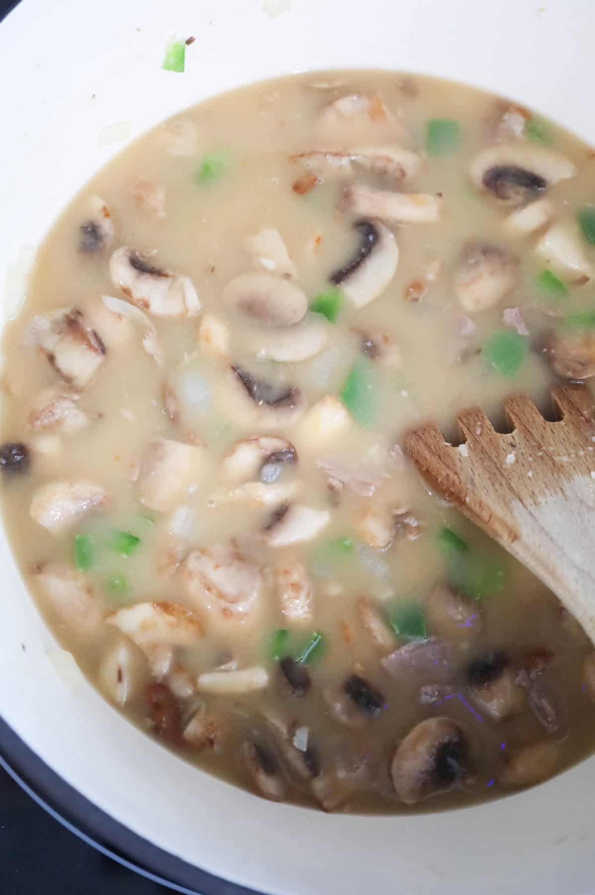 beef broth added to Dutch oven with mushrooms, onions and green peppers