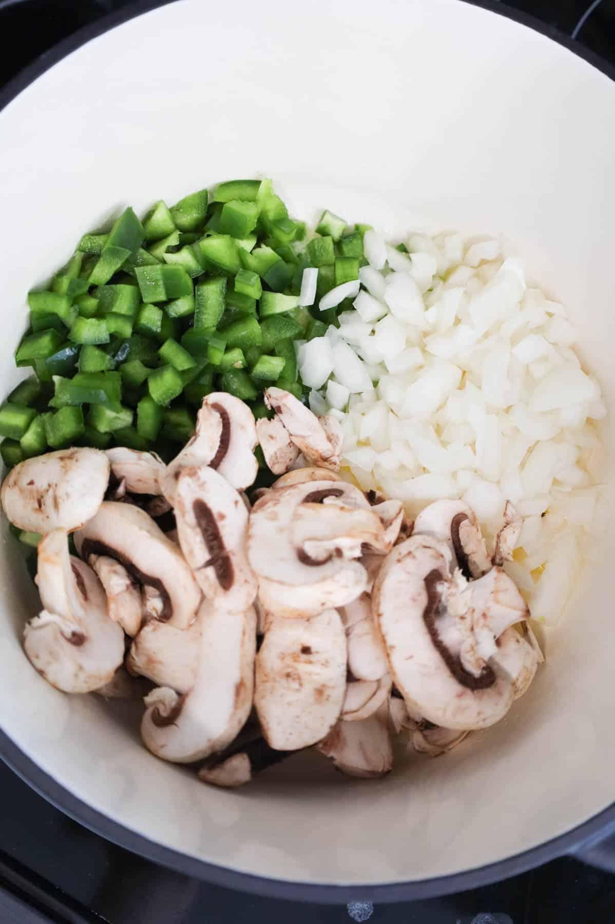 green peppers, diced onions and sliced mushrooms in a Dutch oven