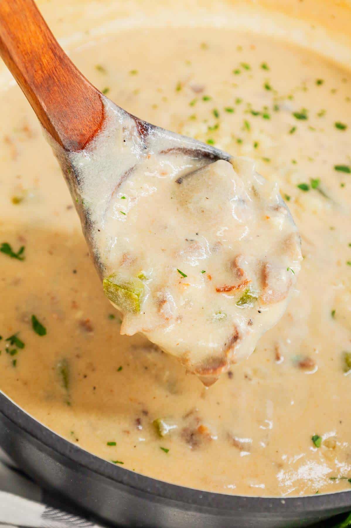 Philly Cheese Steak Soup is a hearty soup loaded with chopped deli roast beef, diced onions, green bell peppers, sliced mushrooms and provolone cheese.