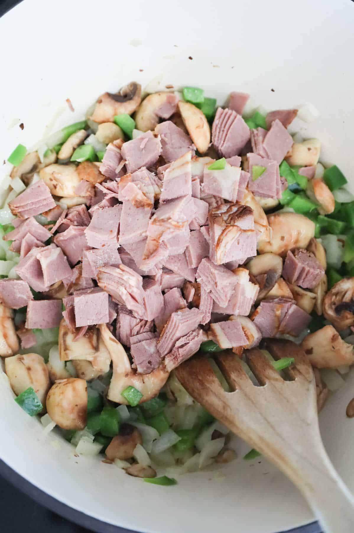 chopped roast beef added to Dutch oven with green peppers, onions and mushrooms