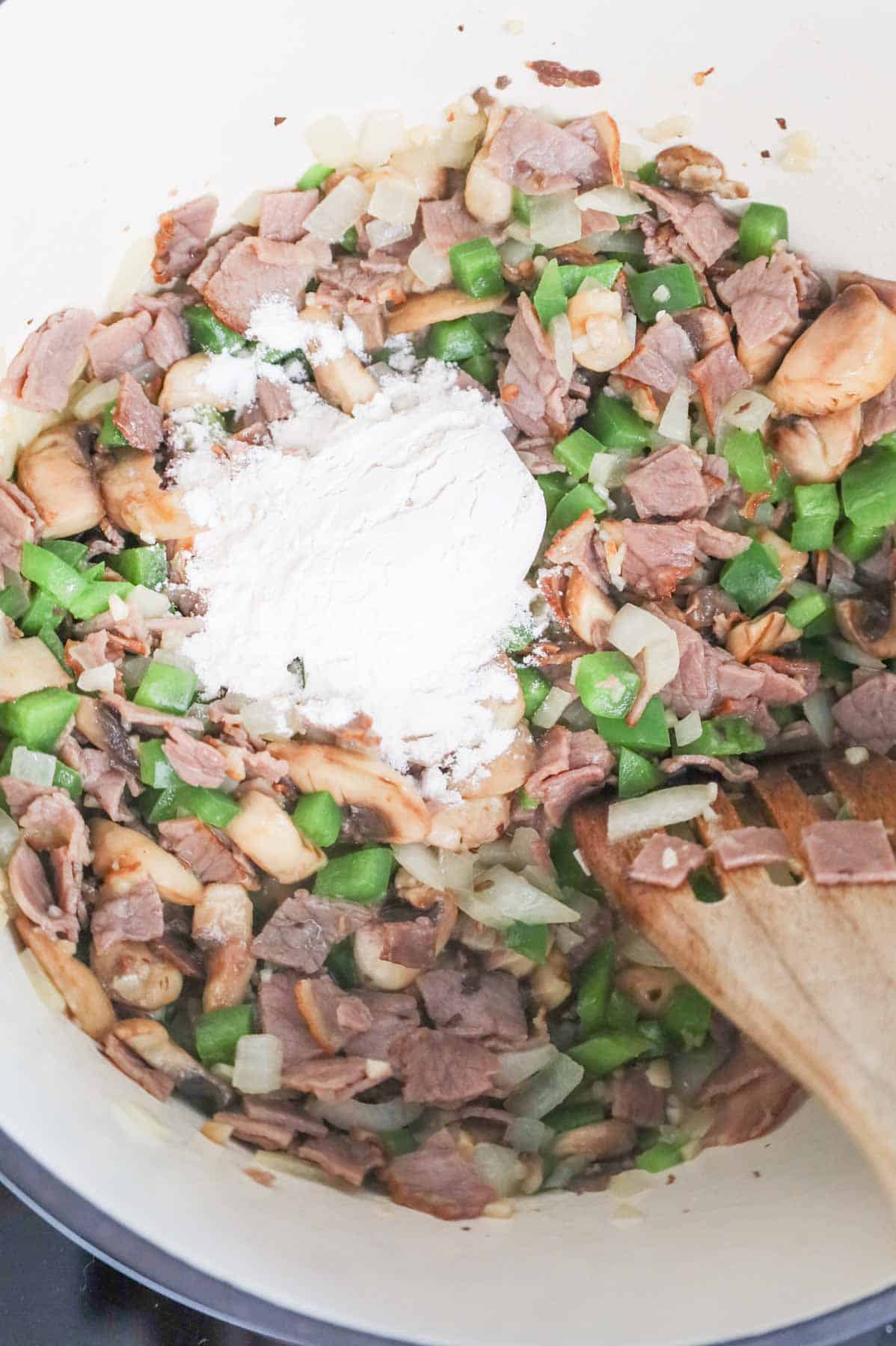 flour added to pot with chopped roast beef, green peppers and onions