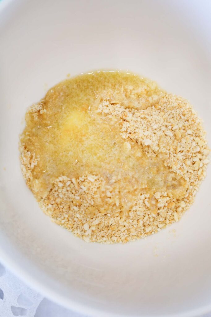 melted butter and Ritz cracker crumbs in a bowl