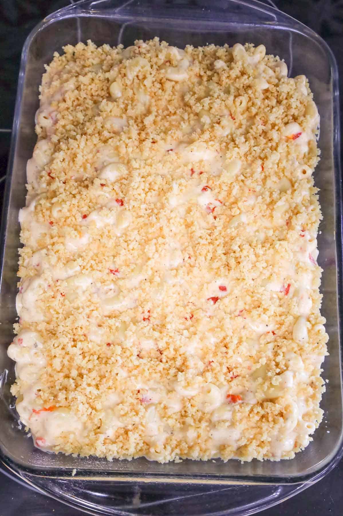 Ritz cracker crumbs sprinkled over mac and cheese in a baking dish