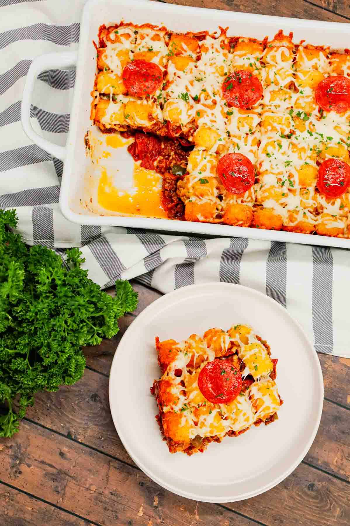 Pizza Tater Tot Casserole is a hearty casserole loaded with ground beef, Italian sausage, pepperoni, green peppers, onions, pizza sauce, mozzarella cheese and crispy tater tots.