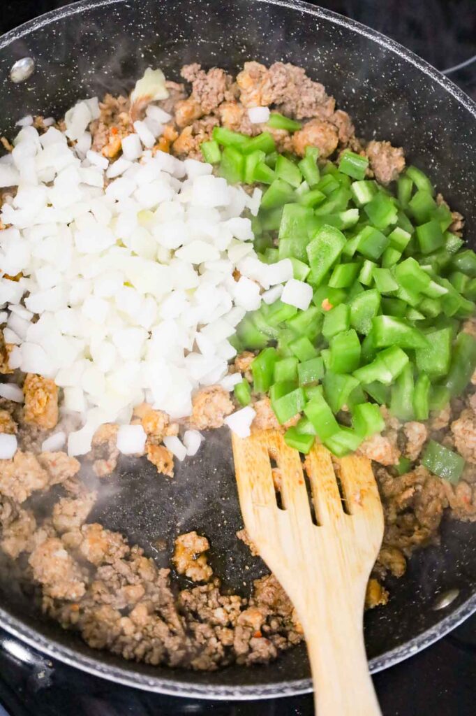 onions and green peppers added to skillet with cooked ground beef and sausage meat
