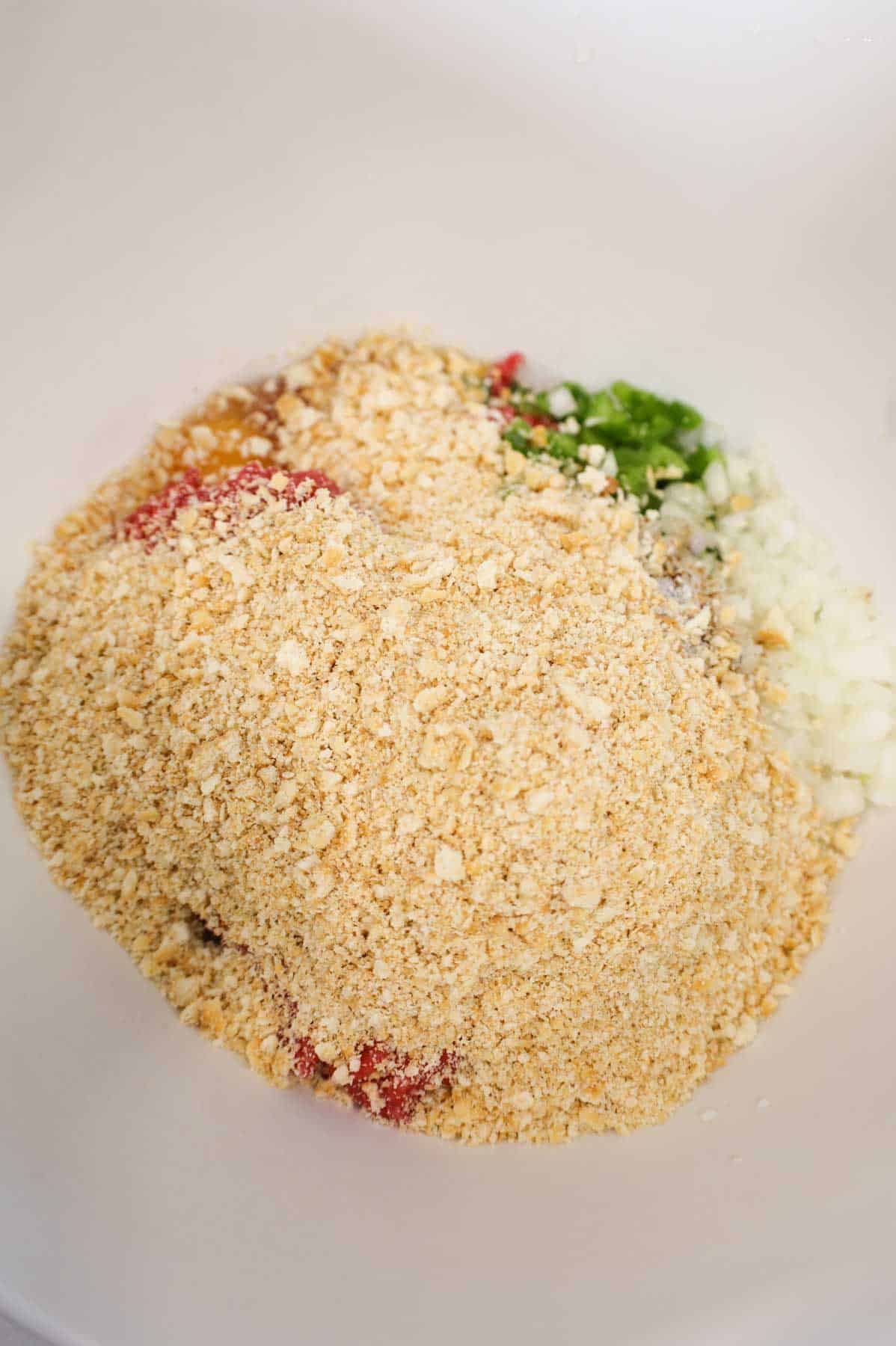 Ritz cracker crumbs added to bowl with other meatloaf ingredients