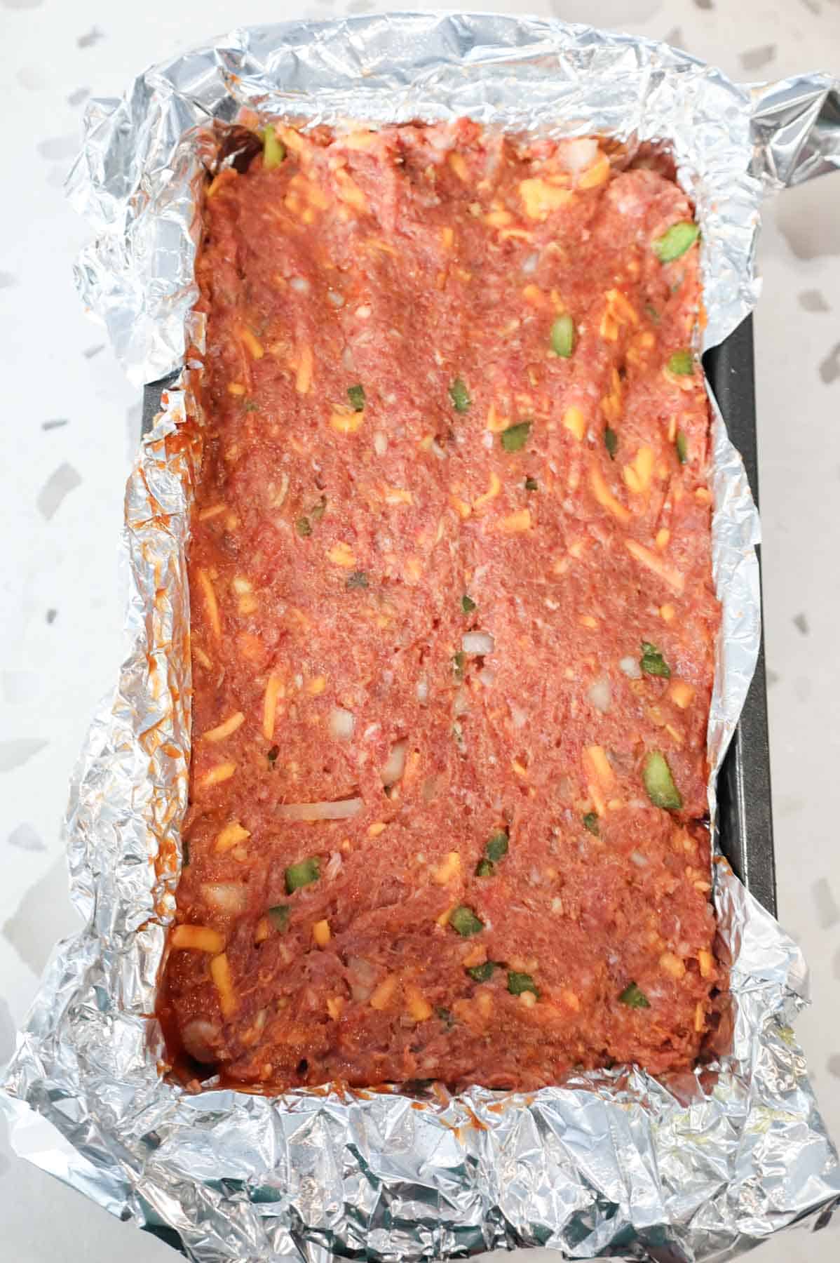 ritz cracker meatloaf mixture pressed into foil lined loaf pan