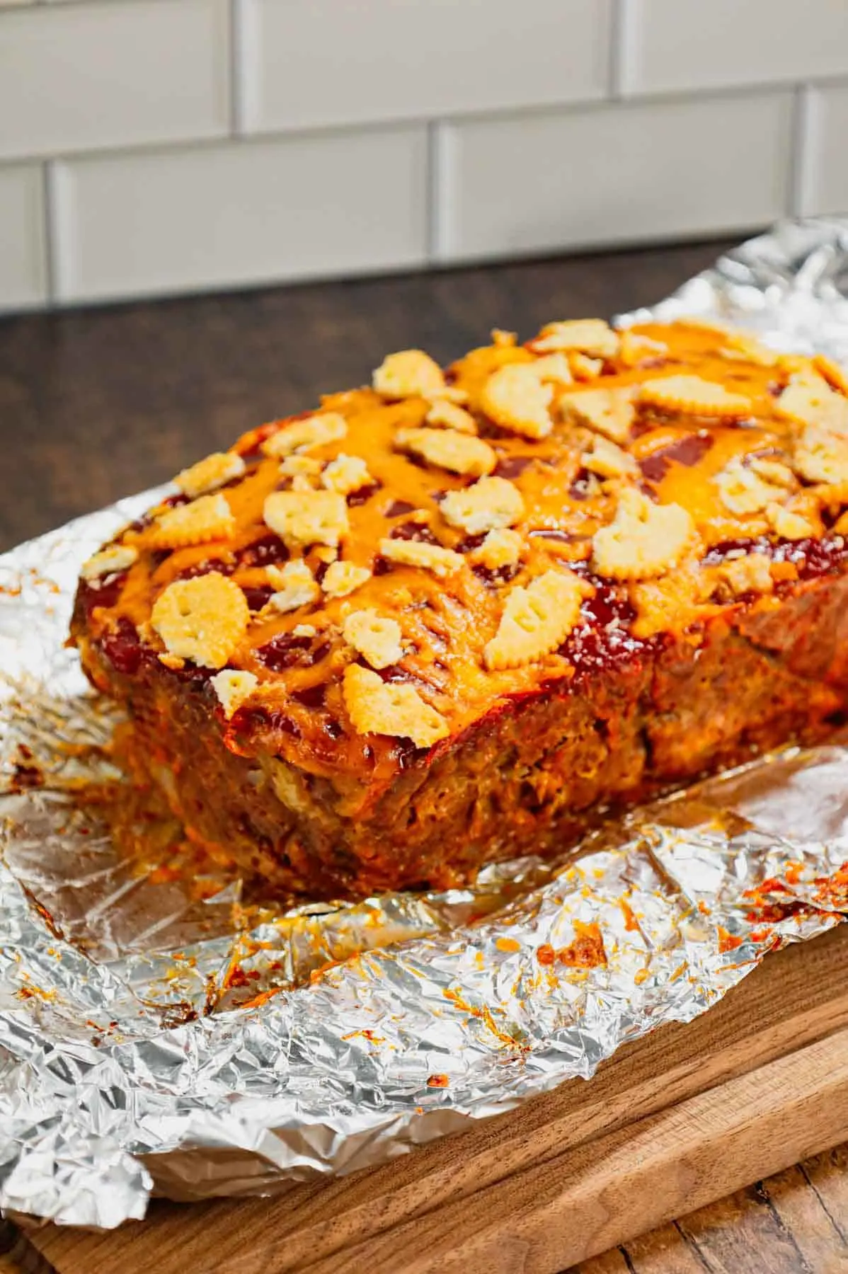 Ritz Cracker Meatloaf is a delicious ground beef meatloaf loaded with crushed Ritz crackers, onion soup mix, onions, green bell peppers and cheddar cheese.