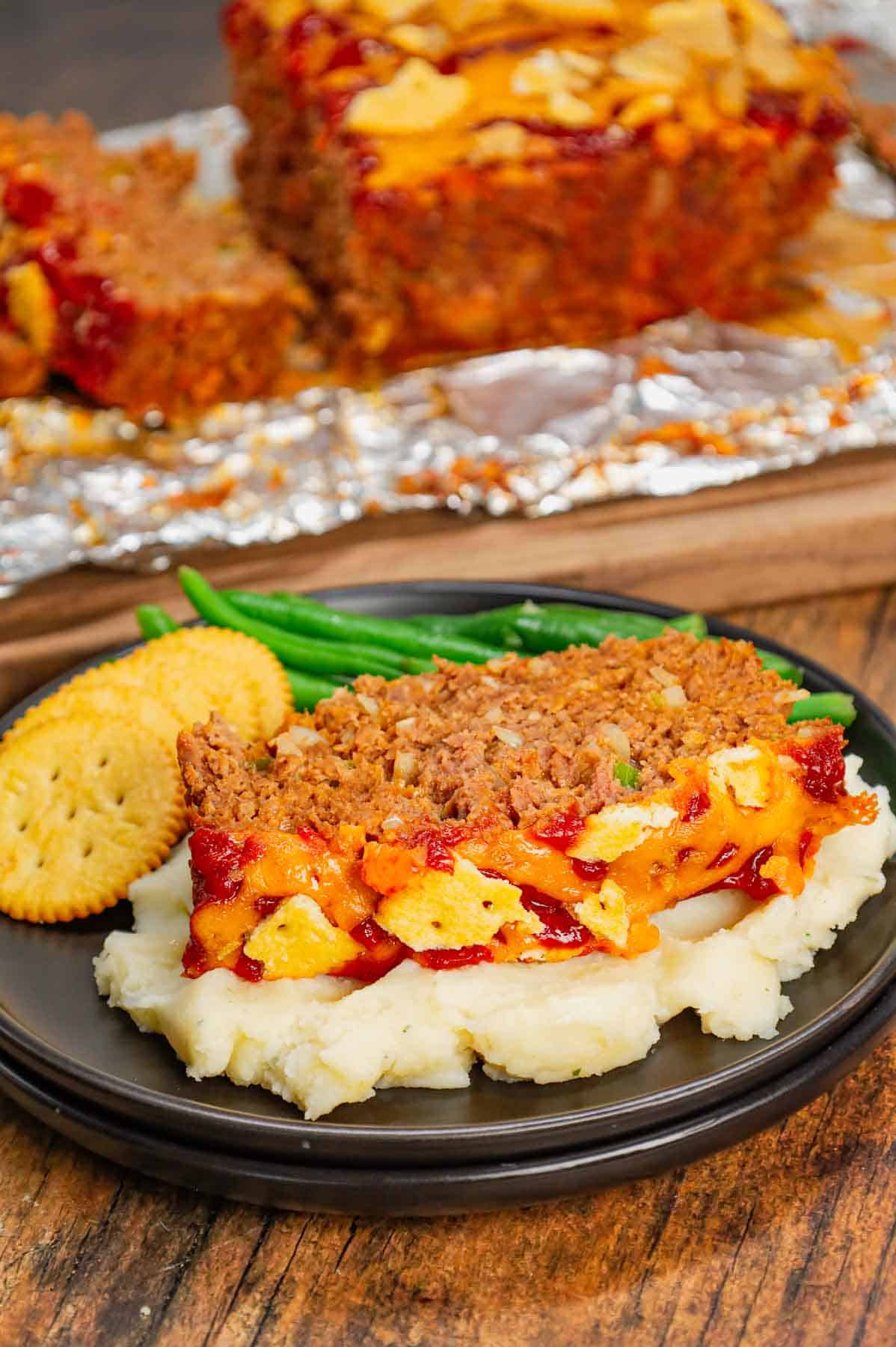 Ritz Cracker Meatloaf is a delicious ground beef meatloaf loaded with crushed Ritz crackers, onion soup mix, onions, green bell peppers and cheddar cheese.