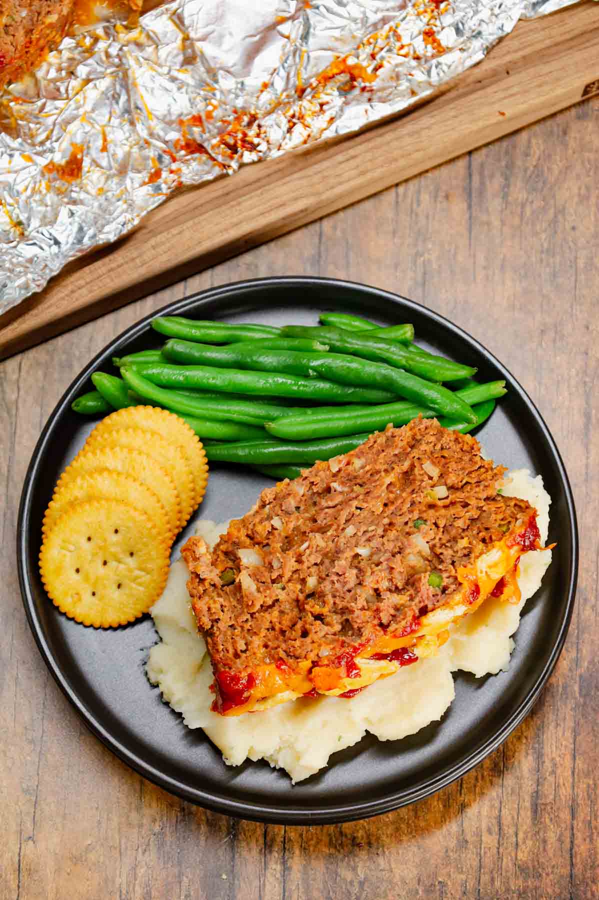 Ritz Cracker Meatloaf is a delicious ground beef meatloaf loaded with crushed Ritz crackers, onion soup mix, onions, green bell peppers and cheddar cheese.