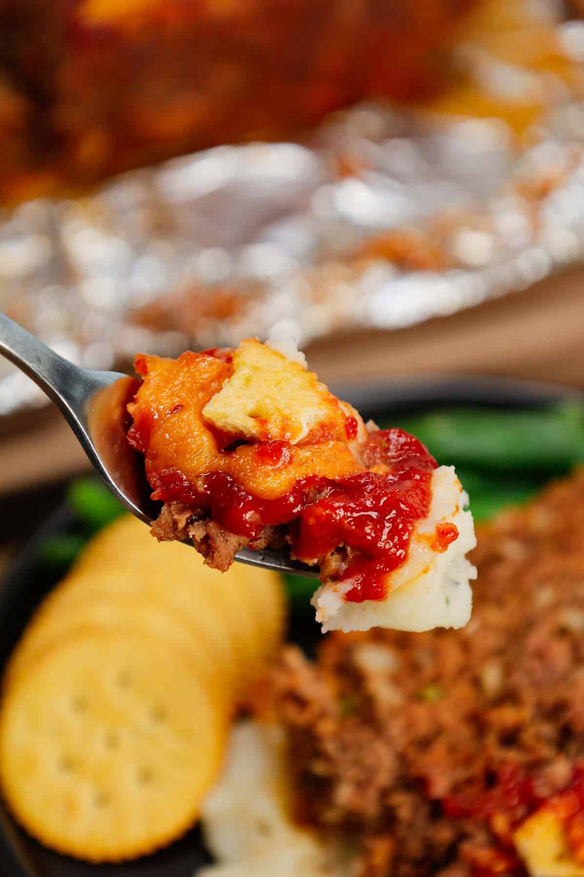 Ritz Cracker Meatloaf is a delicious ground beef meatloaf loaded with crushed Ritz crackers, onion soup mix, onions, green bell peppers and cheddar cheese.