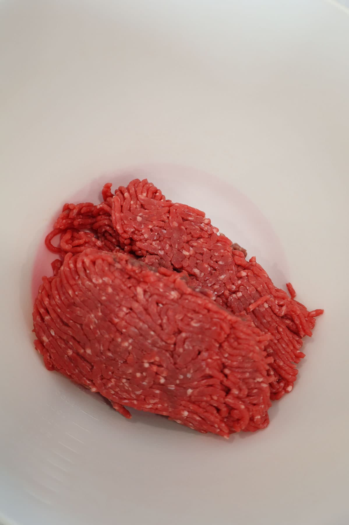 raw ground beef in a mixing bowl