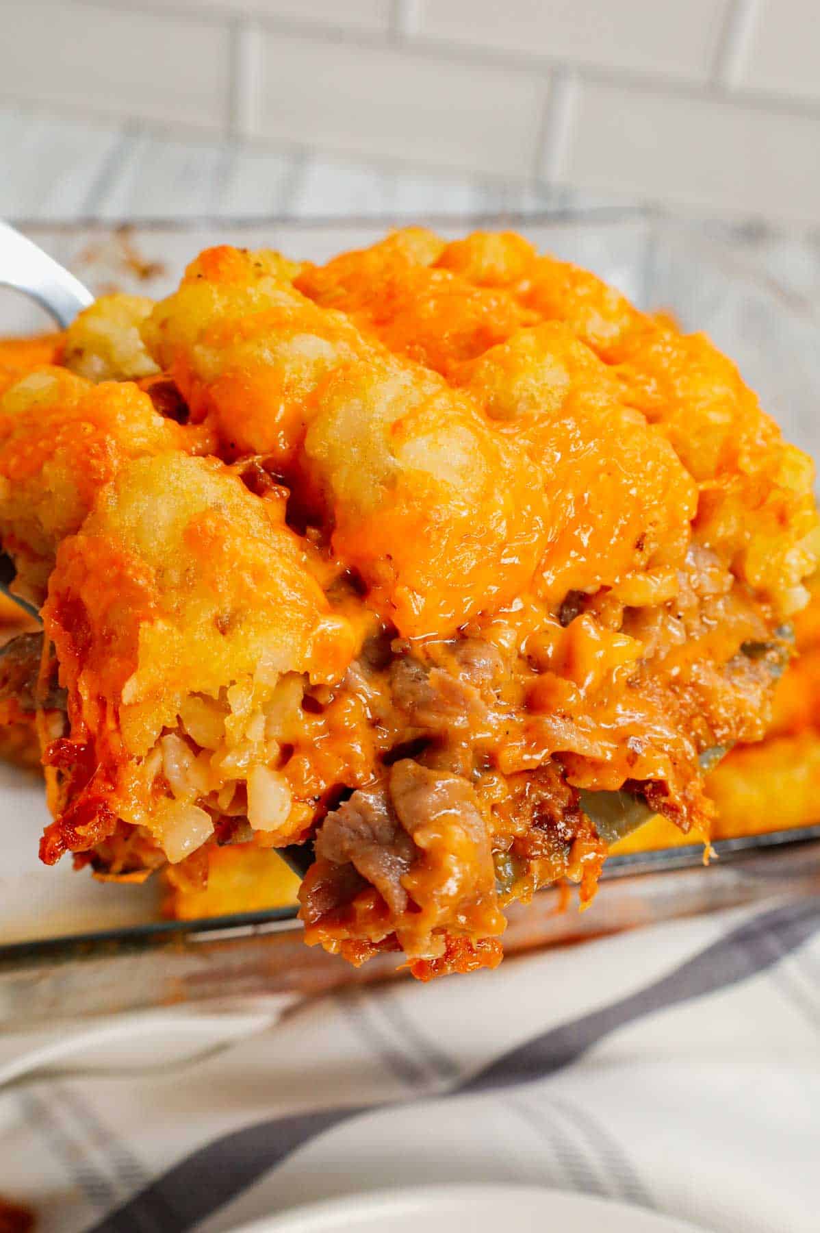 Roast Beef and Cheddar Tater Tot Casserole is a hearty dish loaded with deli roast beef, shredded cheddar cheese, cheddar soup, French's crispy fried onions and tater tots.