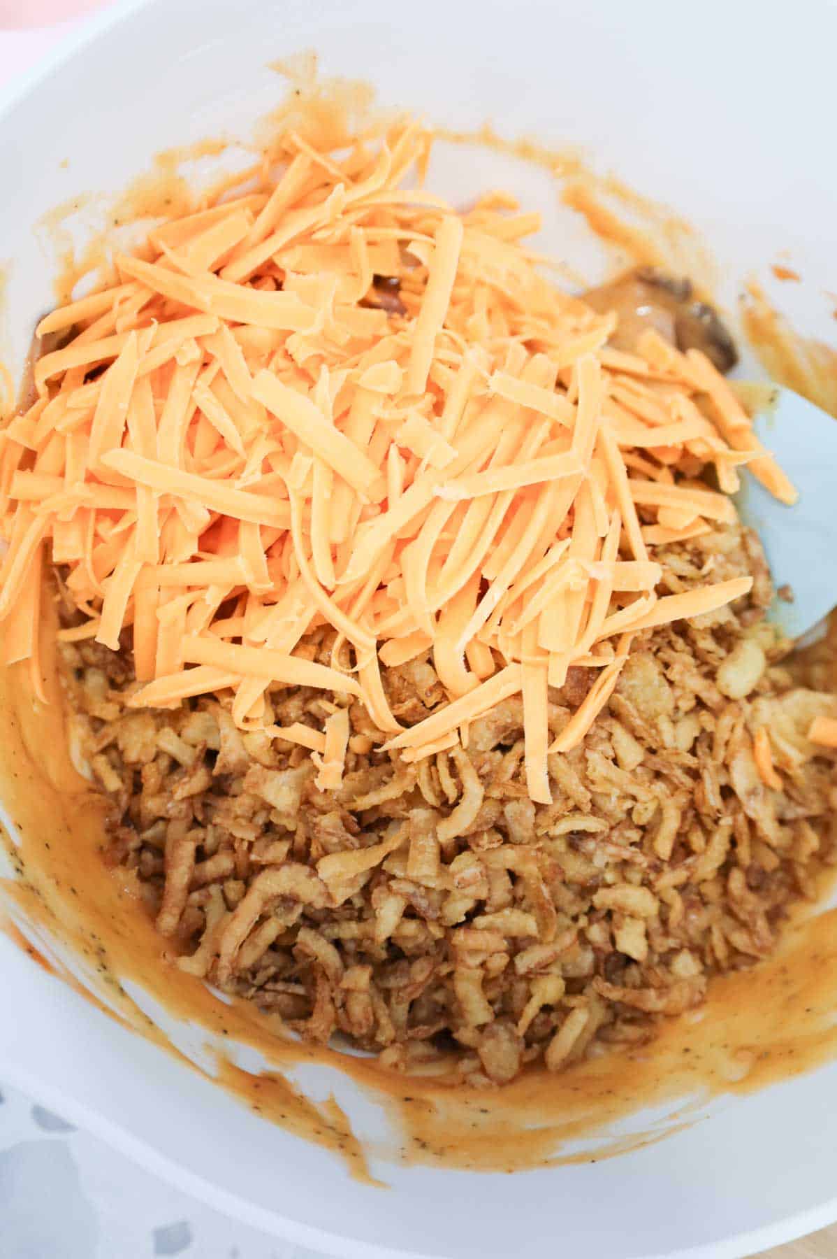 shredded cheddar and French's crispy fried onions in a mixing bowl